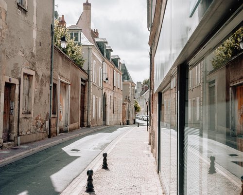 Sunlight reflecting off a quiet residential street in the afternoon